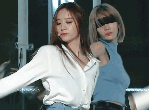 a woman in a white shirt is standing next to another woman