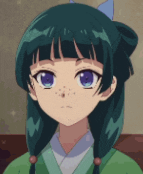 a girl with green hair and blue eyes is wearing a green kimono and a blue bow in her hair .