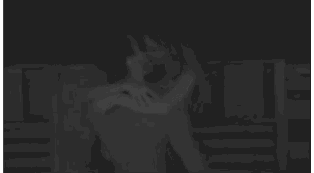 a man and a woman are hugging and kissing in the dark .