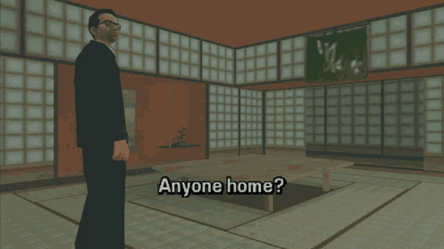 a man in a suit stands in a room with the words anyone home