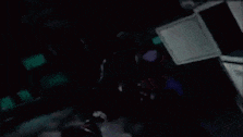 a cartoon character is standing in a dark room holding a sword .
