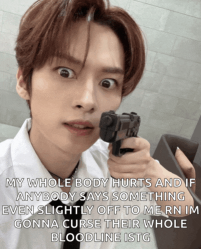 a man is holding a gun with a caption that says my whole body hurts and if anybody says something even slightly off to me