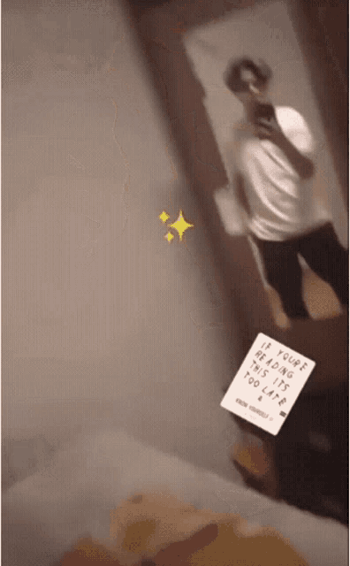a man is taking a picture of himself with a sign that says if youre reading this it too late