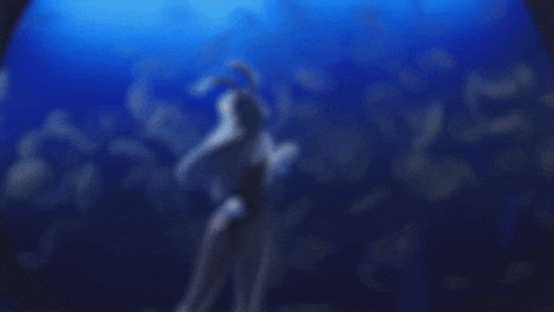 a girl with long hair and bunny ears is standing in the water