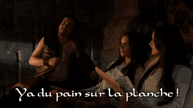 a man without a shirt is standing next to two women with the words ya du pain sur la planche written on the bottom