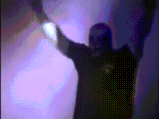 a silhouette of a person with their arms in the air in front of a purple background