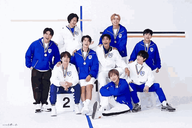 a group of young men posing for a picture with medals around their necks