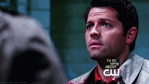 a close up of a man 's face with a tv to bing about cw advertisement behind him .