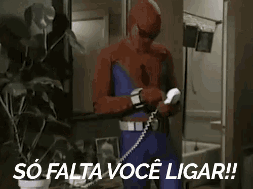 a man in a spiderman costume is talking on a phone and says so falta voce ligar !