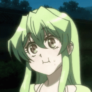 a close up of a cartoon girl with green hair making a funny face .