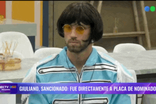 a man wearing a wig and sunglasses is sitting in front of a screen that says directv 360