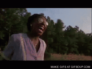 a woman is laughing in a field with trees in the background and the words make gifs at gifsoup.com