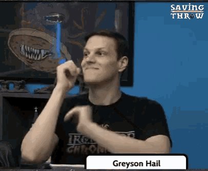 a man wearing a black shirt with the name greyson hail on the bottom