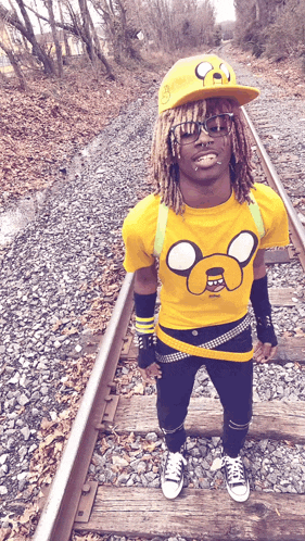 a man wearing a yellow shirt with a mickey mouse face on it