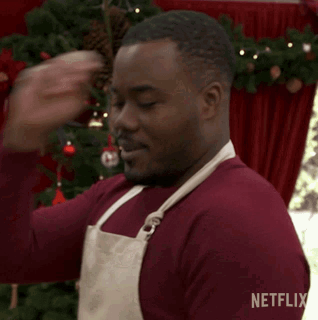a man wearing an apron and a red shirt is a netflix advertisement