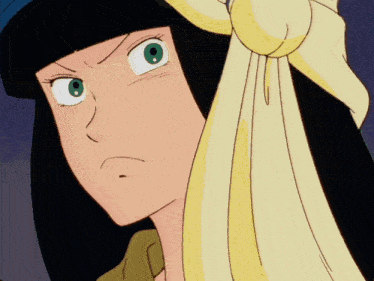 a close up of a woman 's face with a yellow cloth around her head