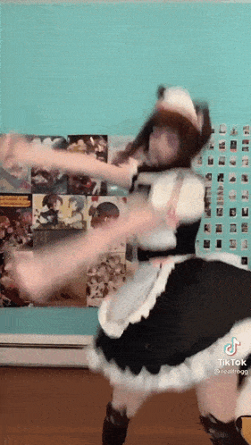 a woman in a maid costume is dancing in a room