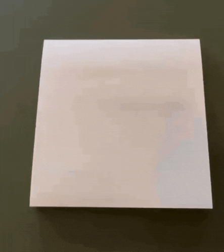 a yellow pencil is being used to write on a piece of white paper