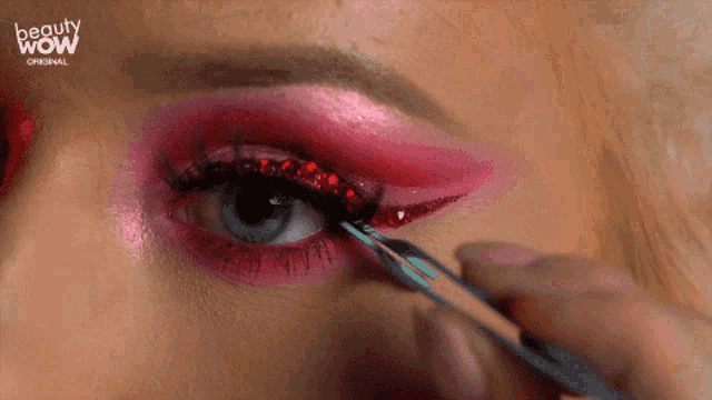 a close up of a woman 's eye with a beauty wow logo in the corner