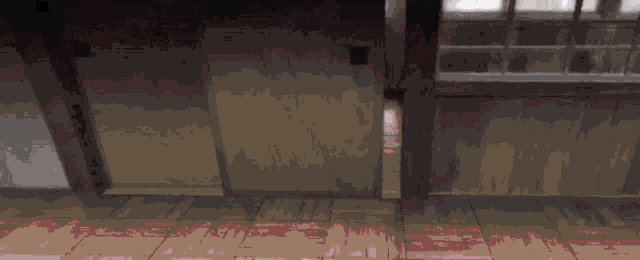 a pixelated image of a person standing on a tiled floor