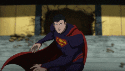a man in a superman costume stands in front of a wall