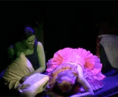 a woman in a pink dress sits next to a woman in a purple dress