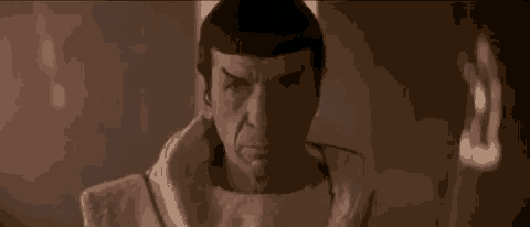 a close up of a man wearing a white robe looking at the camera .