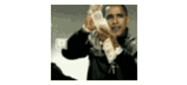 a man in a suit is holding a bunch of money in his hands