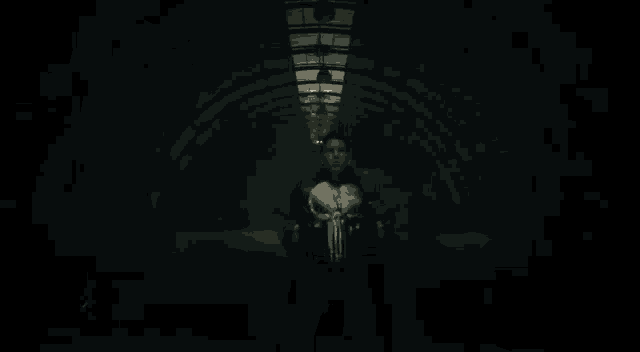 a man in a punisher costume is holding two guns in the dark