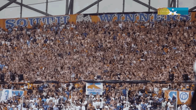 a crowd of people in a stadium with a banner that says south winners