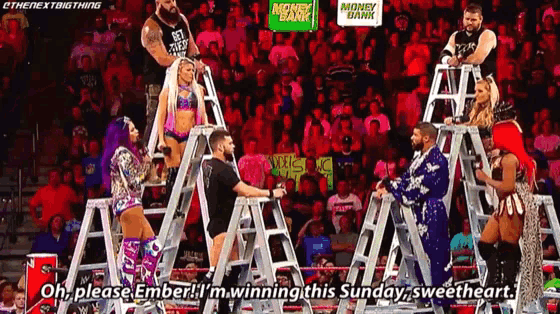 a group of wrestlers are standing on ladder talking to each other on a stage .