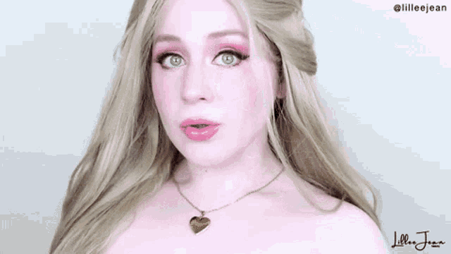 a woman wearing a wig and a necklace with a heart pendant is making a funny face .