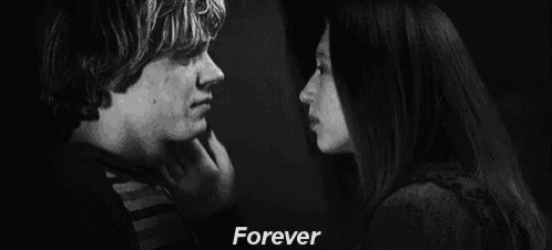 a black and white photo of a person touching another person 's face with the words `` forever '' .