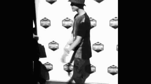 a black and white photo of a man walking