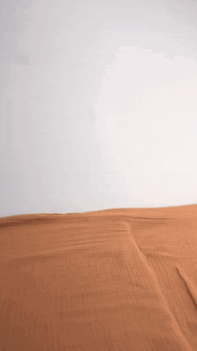 a white wall with a brown cloth on the floor