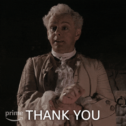 a man in a costume is holding his hand in front of a sign that says thank you