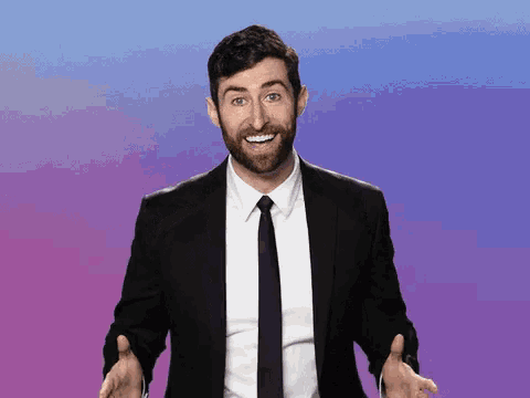 a man in a suit and tie is making a funny face