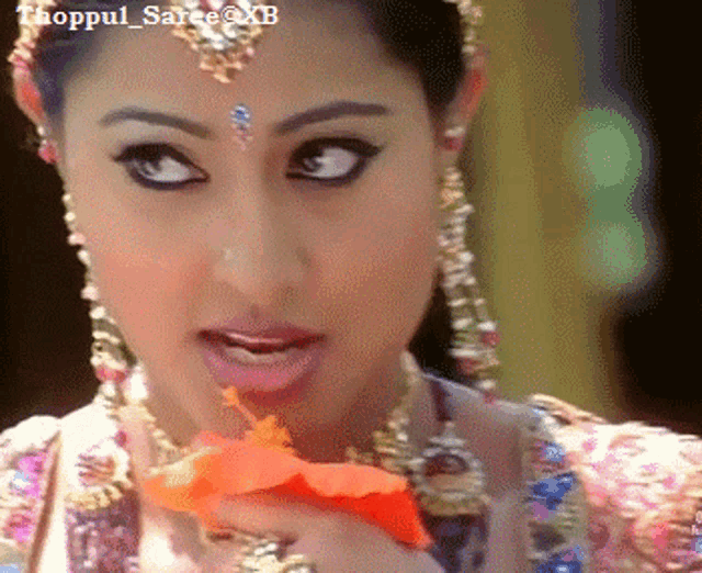 a close up of a woman 's face with the hashtag thoppul_saree @ xb on the bottom