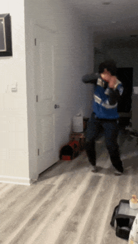 a man in a blue and white sweater is dancing
