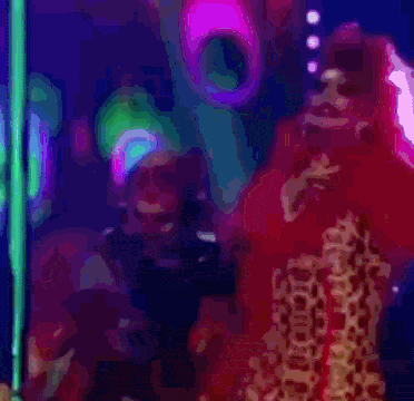 a woman in a red dress is standing in front of a pole