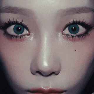 a close up of a woman 's face with a blue eye