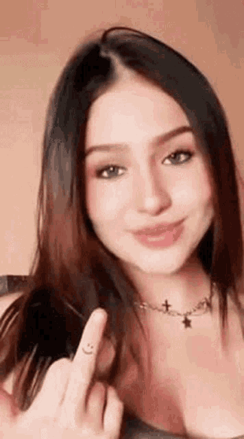a woman with long hair is giving the middle finger .