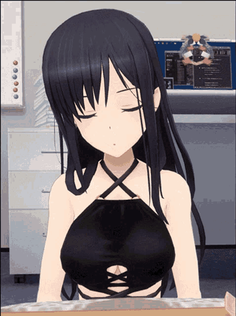 a girl in a black top is sitting in front of a computer monitor