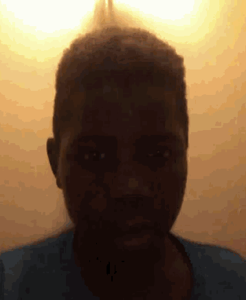 a close up of a person 's face with a light shining on it