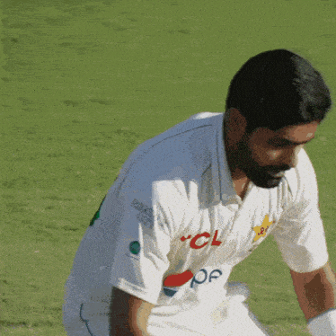 a man wearing a white shirt with the number 6 on the back