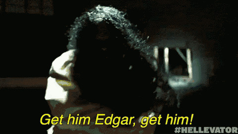 a man with chains around his neck is saying " get him edgar get him "