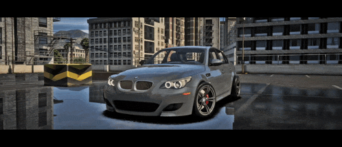 a silver bmw is parked in a parking lot with buildings in the background