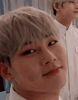 a close up of a man 's face with blonde hair and red lips