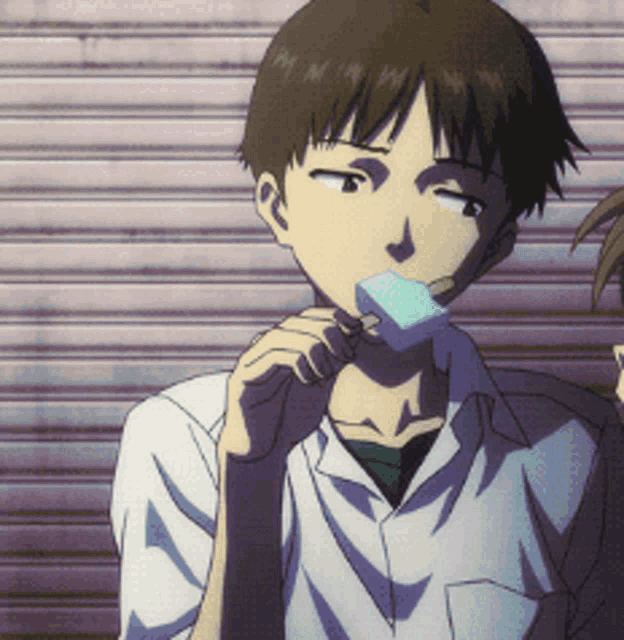 a man in a white shirt is eating a blue ice cream bar