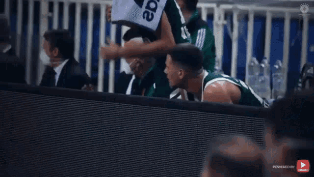 a basketball player wearing a green jersey with the number 2 on it